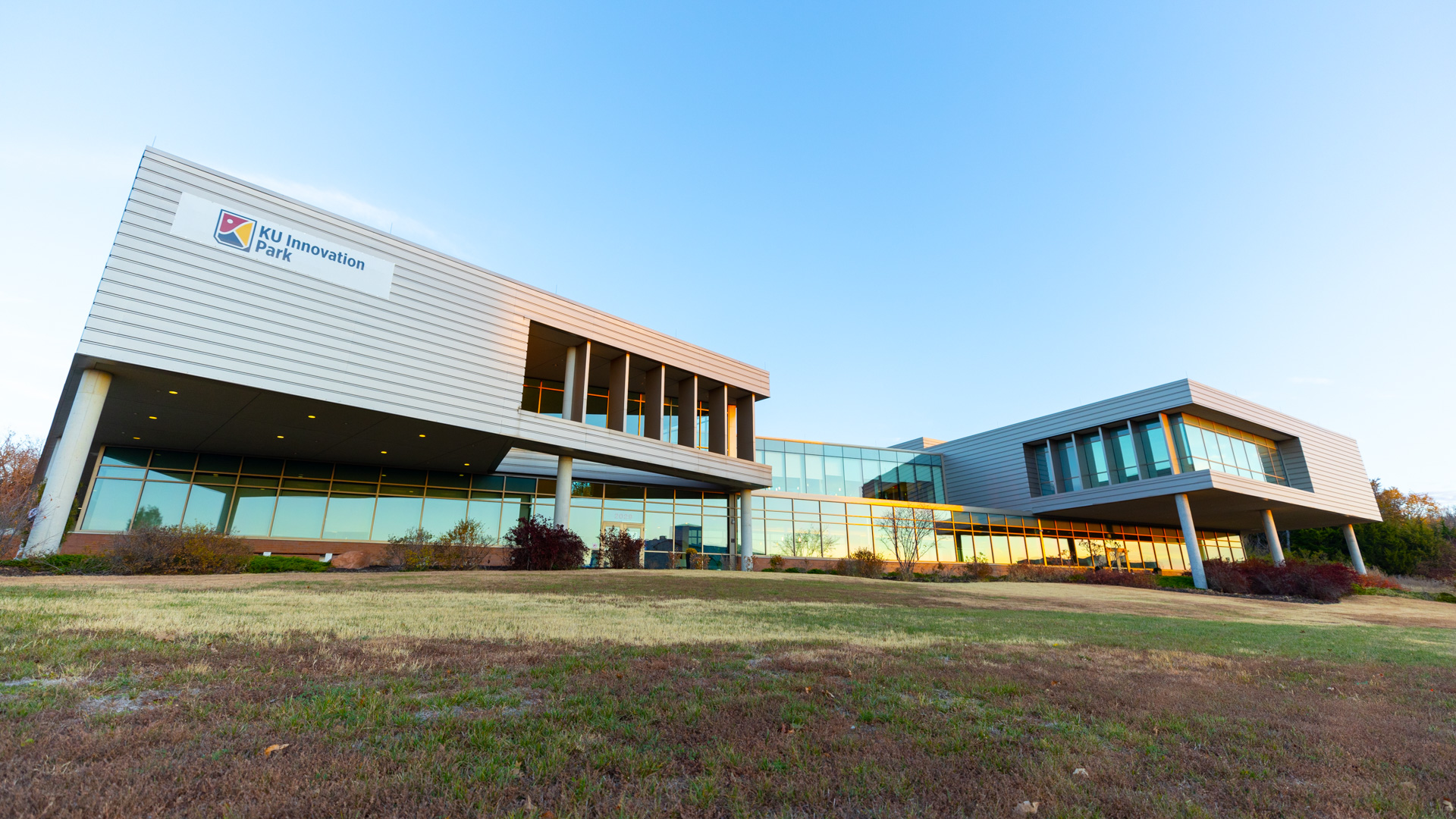 A portrait of the KU Innovation Park building from the grass.