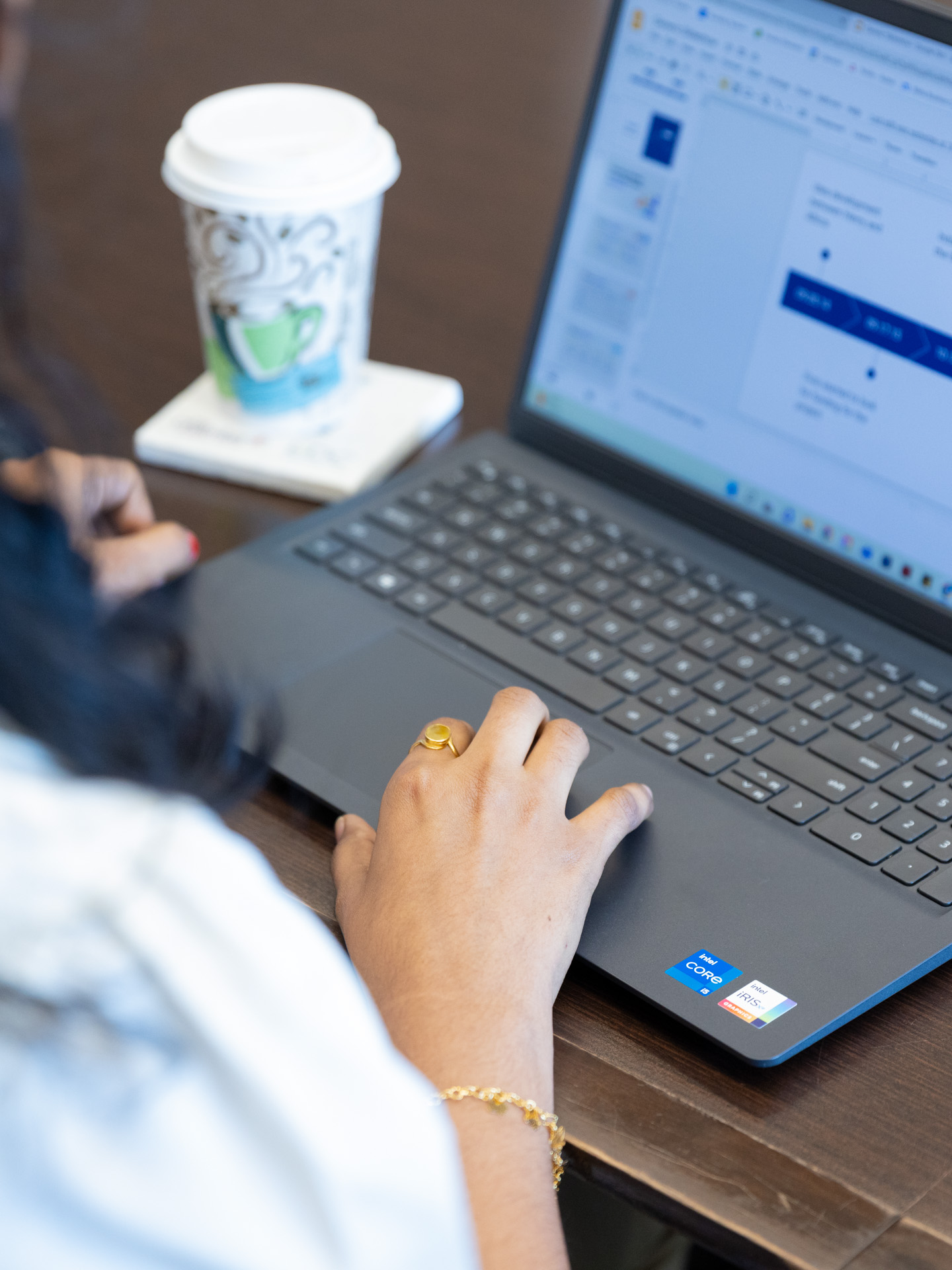 A person sits at a desk while clicking on a laptop at the Bioscience and Technology Business Incubator in Lawrence, KS.